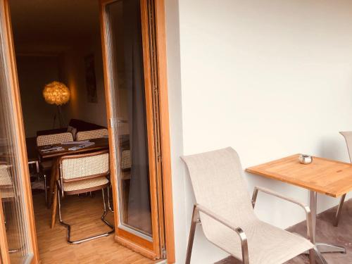 a dining room with a table and a chair and a mirror at Apartmenthotel Oberstdorf in Oberstdorf