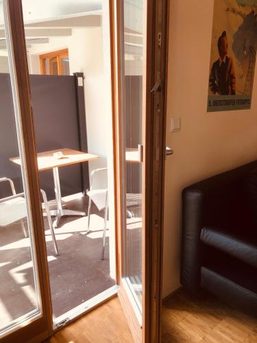 a glass door leading into a room with a table at Apartmenthotel Oberstdorf in Oberstdorf