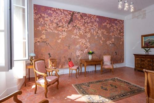 a room with a table and chairs and a wall at Bastide Saint-Estève in Brue-Auriac