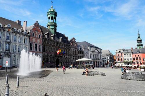 a city square with a fountain in front of a building at Pink studio Mons ✓ TOP position ! in Mons