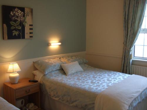 a small bedroom with a bed and a window at Shannonside House N37HF67 in Athlone