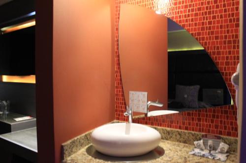 a bathroom with a sink and a mirror at Hotel Lua in Mexico City