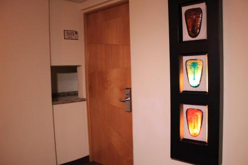 a door with some stained glass panels on it at Hotel Lua in Mexico City