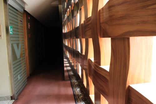 a hallway in a building with a wooden wall at Hotel Lua in Mexico City