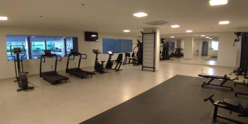 a gym with treadmills and exercise equipment in a building at Park Veredas- Rio Quente Temporada in Rio Quente