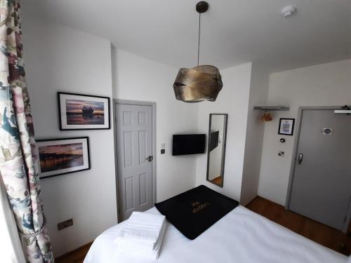 a bedroom with a bed with a black pillow on it at Number 8 in Canterbury