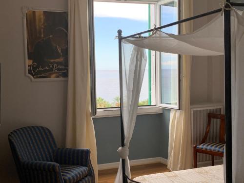 a room with a couch, chair and a window at Grand Hotel & des Anglais Spa in Sanremo
