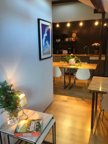a living room with a table and a dining room at B&B Setola in Bruges