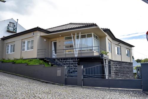 a house with a staircase in front of it at A Casa do Outeiro in Ribeira Grande
