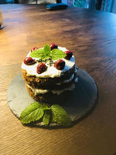 a dessert with whipped cream and cherries on a table at Hotel Am Moosrain Garni in Eitting