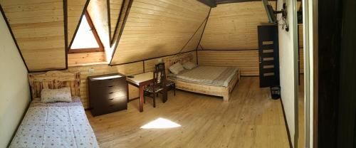 a room with a bed and a desk in a cabin at Сімейний еко-готель "Вежа Бойка" in Skole