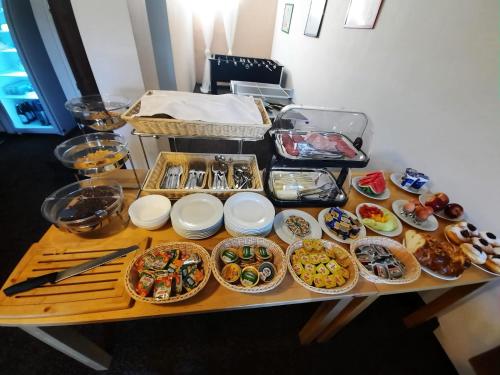 a table topped with lots of different types of food at Penzion Garden in Cerny Dul