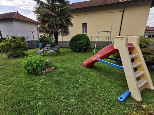 a playground with a slide in a yard at Grandma's garden house in Angera