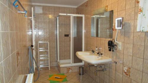a bathroom with a sink and a shower at Ferienhaus Englbrecht in Krispl