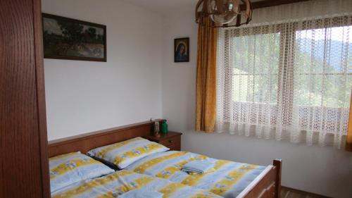 a bedroom with a bed and a window at Ferienhaus Englbrecht in Krispl