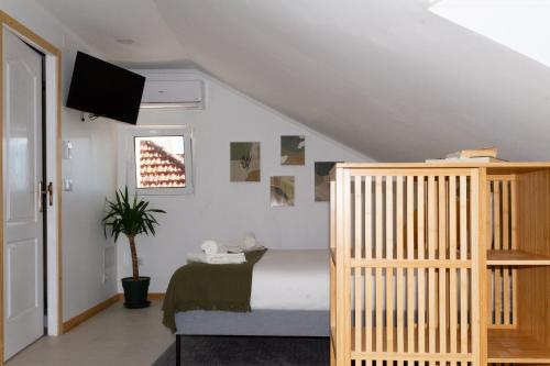a bedroom with a bed and a crib at Seixal Bay Apartments in Arrentela
