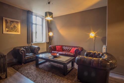 a living room with two couches and a coffee table at La Merveilleuse by Infiniti hôtel in Dinant