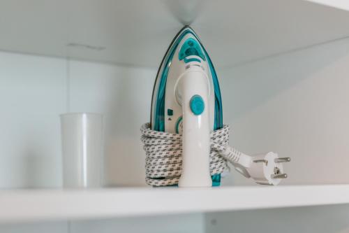 a blue and white iron sitting on a shelf at WS Tour Eiffel - Nicolo in Paris