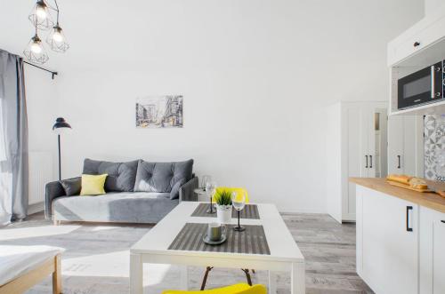 a living room with a couch and a table at GoldAparts Centrum in Łódź