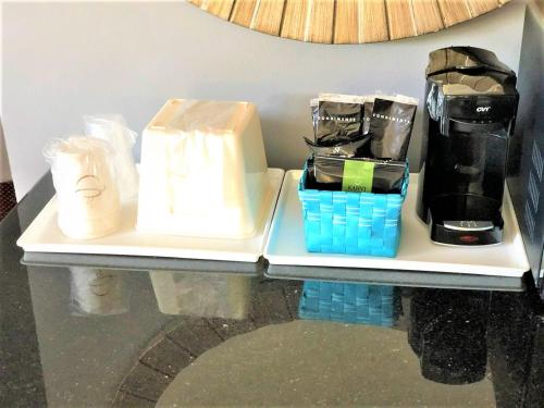 a shelf with a coffee maker and other items on it at Countryside Inn Richmondville in Richmondville