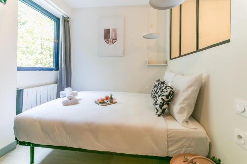 a small bed in a room with a window at WS Tour Eiffel - Nicolo in Paris