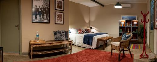 a bedroom with a bed and a table and a desk at Gerthrudes Bed & Breakfast in Rio de Janeiro