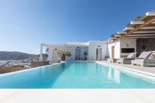 a swimming pool in front of a villa at SeaCode Villas in Platis Gialos