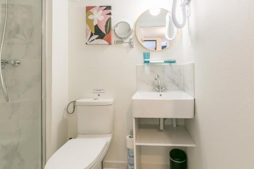 a bathroom with a toilet and a sink and a mirror at WS Tour Eiffel - Nicolo in Paris