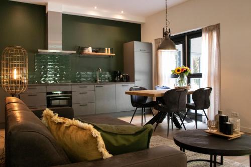 een woonkamer met een bank en een tafel bij Villa Woudstee in Vierhouten
