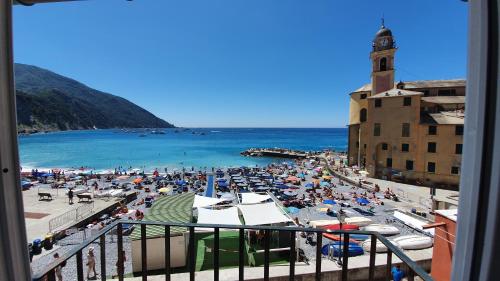 a view of a beach with a crowd of people at Best flat beachfront Camogli in Camogli