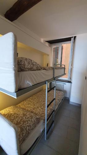 two bunk beds in a room with a window at Best flat beachfront Camogli in Camogli