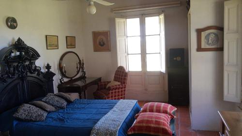 a bedroom with a bed and a window and a door at El Tramway Casa Antigua de Campo in San Antonio de Areco