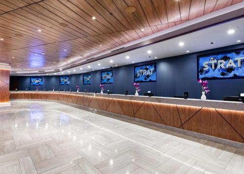 a lobby with a waiting area with blue walls at The STRAT Hotel, Casino & Tower in Las Vegas