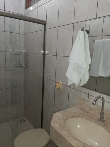 a bathroom with a sink and a toilet and a shower at Pousada Paraiso in Bonito