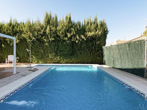 a swimming pool in a yard with a fence at Belvilla by OYO Casa de Rudi in Seville