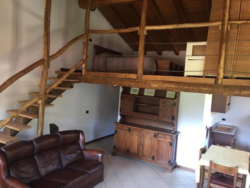 a living room with a couch and a loft at Agriturismo Il Balcone sulla Valle in Bedero Valcuvia