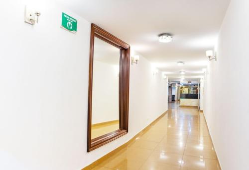 a hallway in a hospital with a mirror on the wall at Hotel Thama in Palmira