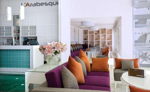 a lobby with purple and orange pillows and a table at Radisson Blu Resort & Thalasso Hammamet in Hammamet