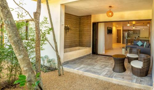 a room with a shower and a living room at Albra Tulum in Tulum