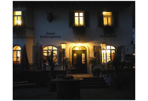 a building lit up at night with a front door at Hotel Kolbergarten in Bad Tölz