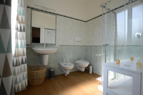 a bathroom with two toilets and a sink and a shower at CASA BLANCA in Latina