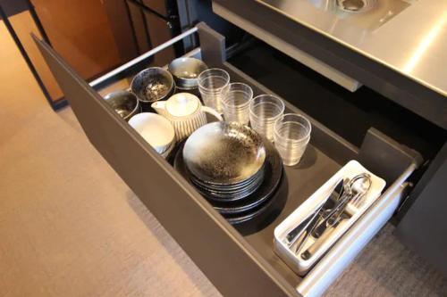 a drawer with dishes and utensils in a kitchen at T-home2 1F in Tokyo