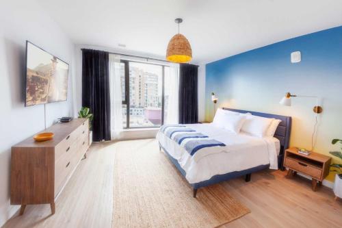 a bedroom with a large bed and a large window at The Laundry Rooms - Waterloo in Waterloo