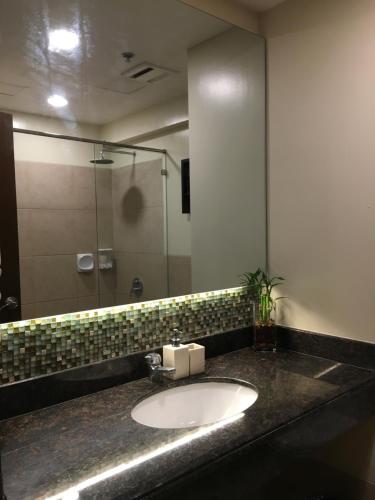 a bathroom with a sink and a mirror at Outlook Ridge Residences - North in Baguio