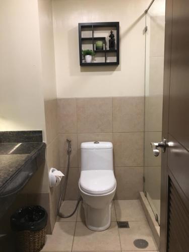 a bathroom with a toilet and a picture on the wall at Outlook Ridge Residences - North in Baguio