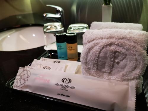 a bathroom with two towels and a sink at Grand Paragon Hotel Johor Bahru in Johor Bahru