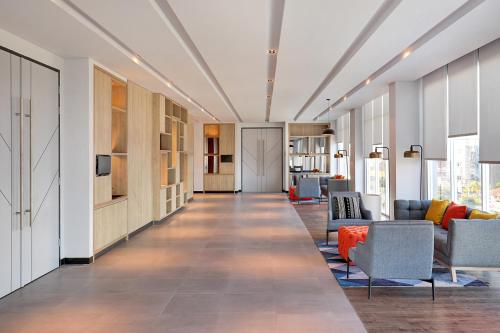 a hallway with couches and chairs in a building at Ibis Samarinda in Samarinda