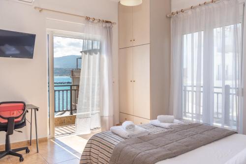 a bedroom with a bed and a window with a balcony at Sitia Old Port Apartment in Sitia