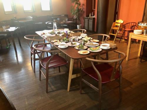 a wooden table with plates of food on it at Appi Life is Beautiful in Hachimantai