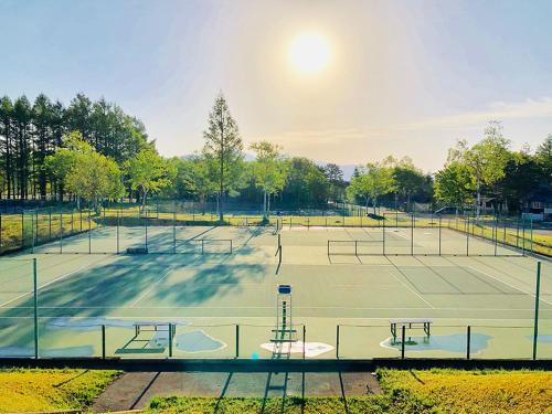 a group of tennis courts with the sun shining at Appi Life is Beautiful in Hachimantai